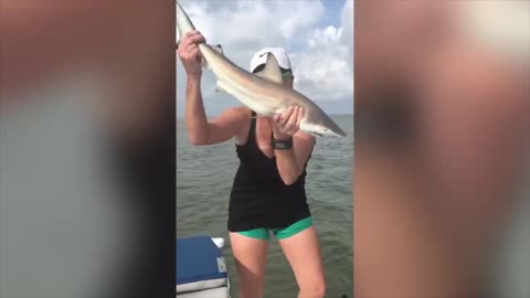 The girl caught a shark, but she lost control