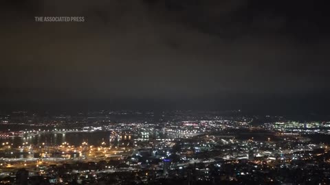 Security personnel clear rubble after sirens and blasts heard in Haifa