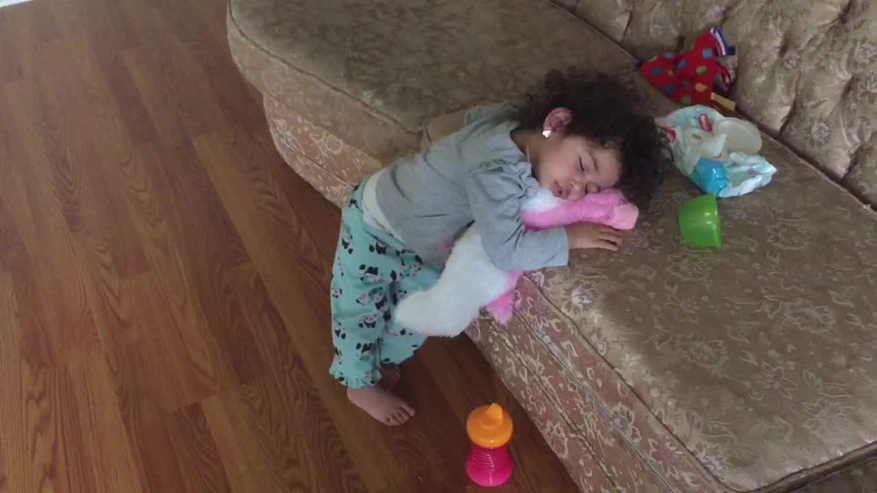 Little girl falls asleep in upright position