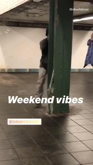 Guy dances with a metal beam inside subway station
