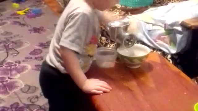 the boy turns pasta through a meat grinder