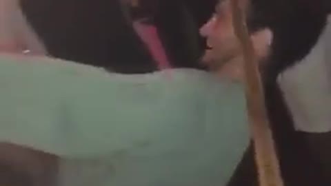 Guy in green sweatshirt falls down trying to limbo