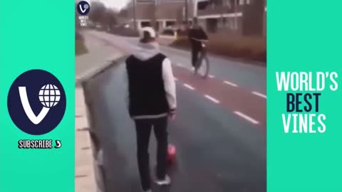Guy kicks fake soccer ball at bicyclist