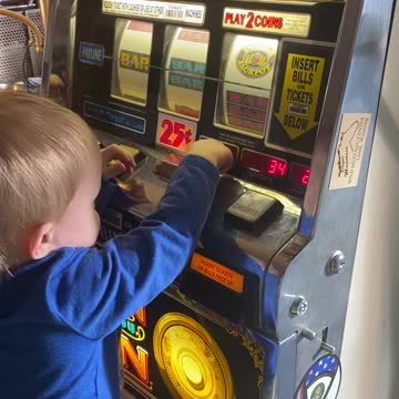 Grandson playing with grandpa’s piggy bank.
