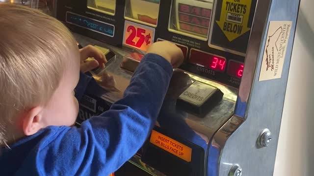 Grandson playing with grandpa’s piggy bank.