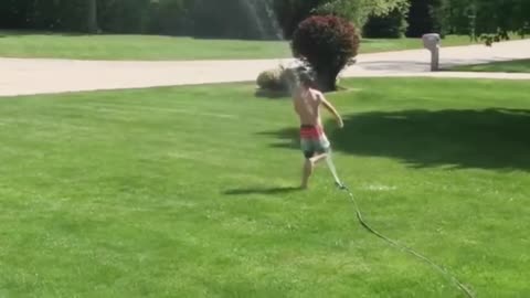 watch funny baby playing with water