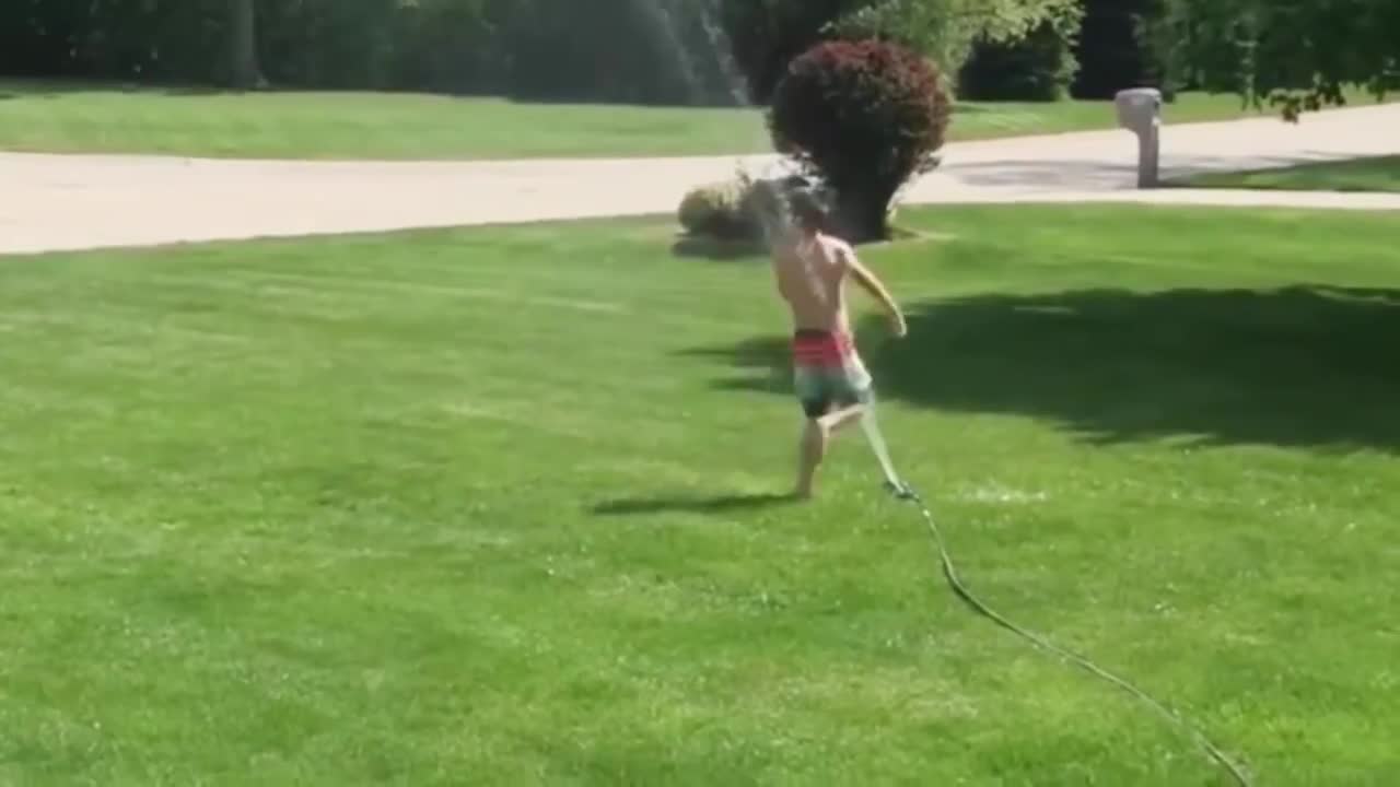 watch funny baby playing with water