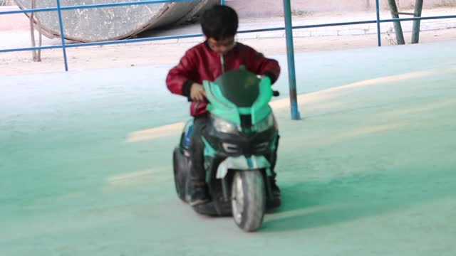 Little kids are enjying driving of bikes and cars