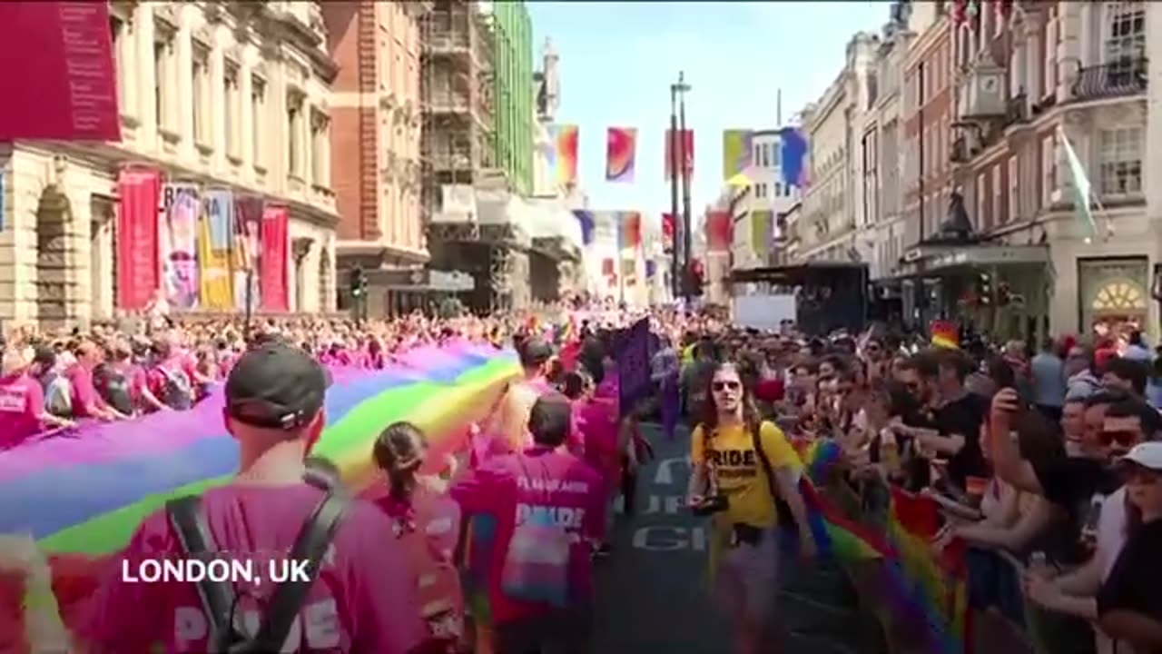 Sun shines on tens of thousands of revellers joining annual Pride parade in central London