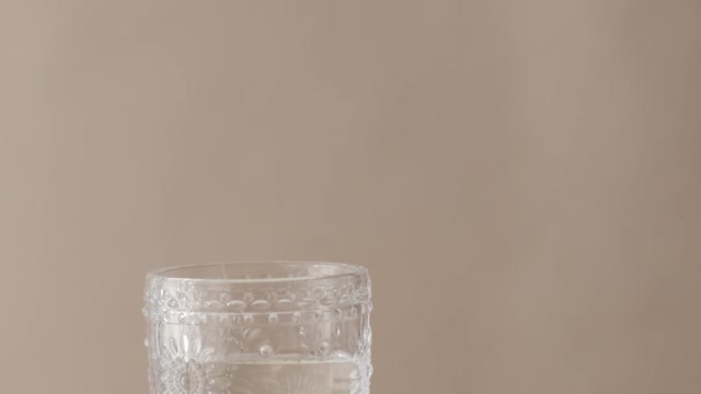 a-sliced-lime-dropped-in-a-glass-with-water