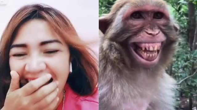 a woman and a monkey laughing together.