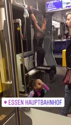 Man in black and white headphones pull ups on bus