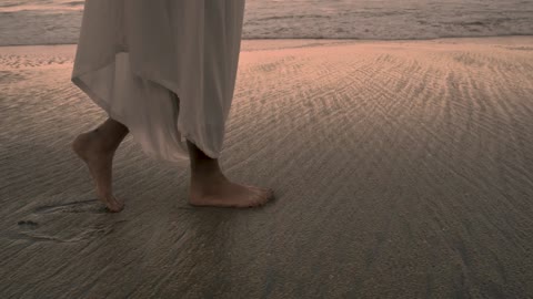 Feet Walking On The Beach