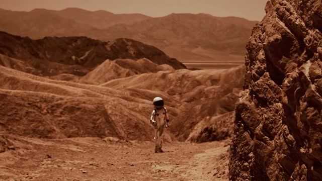 an-astronaut-walking-in-a-desert