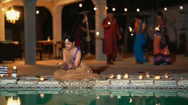 The beautiful girl is floating candle on water