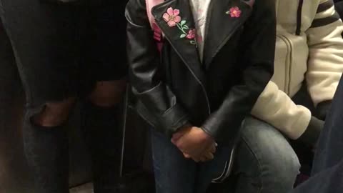 Young girl balances fidget spinner on forehead