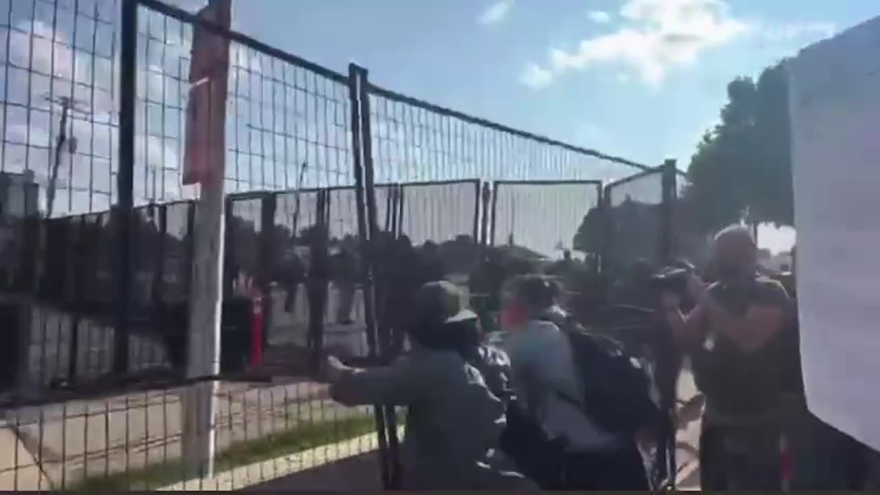 Paid Protestors Bring Down Fence At DNC.