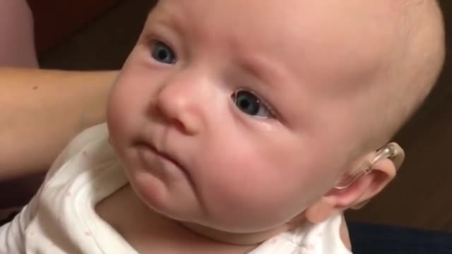 The baby hears his mom for the first time and is almost moved to tears!