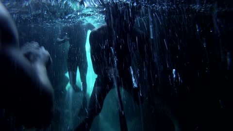 Swimming underneath a dark underwater cave