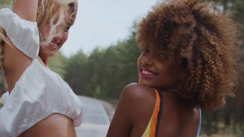 Women Riding at the Back of a Truck