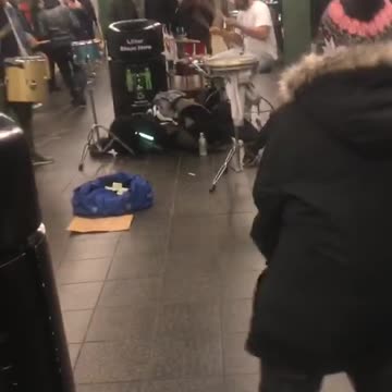 Little boy does the floss dance and the splits in subway station
