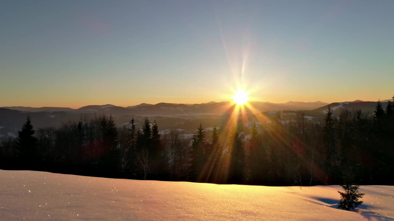 Sunrise sun flare in the snowy mountains