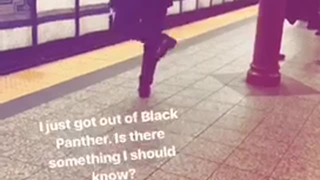 Man uses umbrella as pretend sword on subway platform