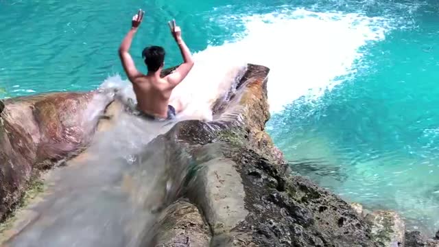 Enjoying the Natural Waterslide in Kawasan Falls