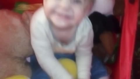 Child playing in a basket for toys