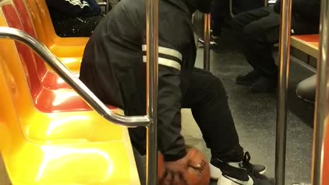 Man dribbles ball on subway train