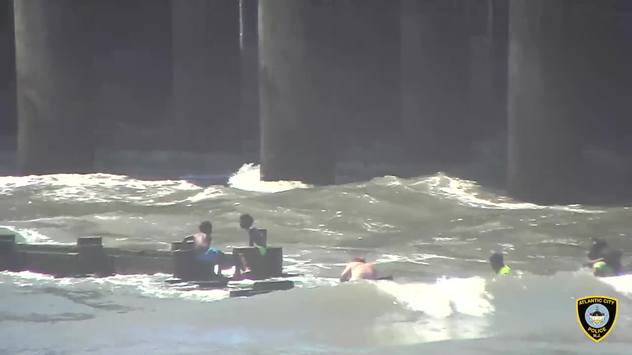 Kids get crushed by waves as they hold onto a pipe, firefighters & officers pull them to safety