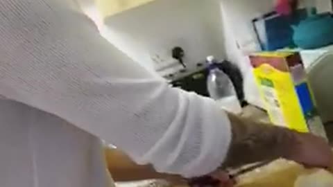 White shirt guy uses black goggles to cut onions