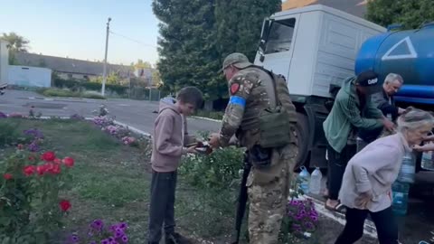 Ukrainian Soldiers Hand Out What Ever Food They Have To Civilians