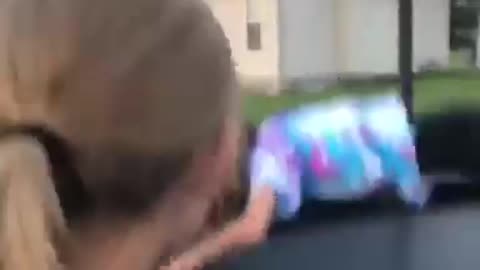 Girl in tie dye shirt faceplants in trampoline