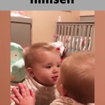 cute baby looking at himself