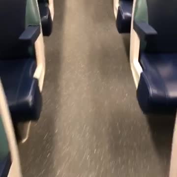 Black harry potter broom in empty seat on subway