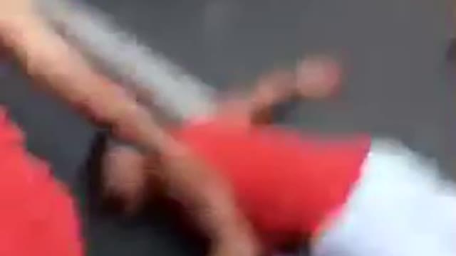 Red shirt white shorts back flip in street hits head on ground