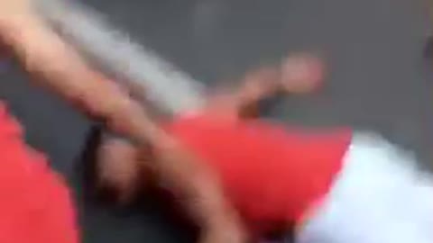 Red shirt white shorts back flip in street hits head on ground