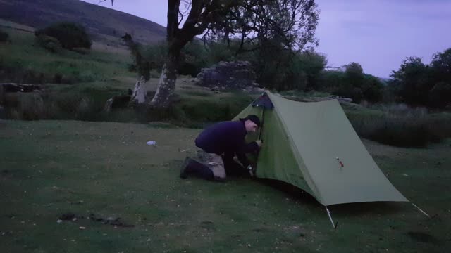 Putting up trekking pole tent at night..