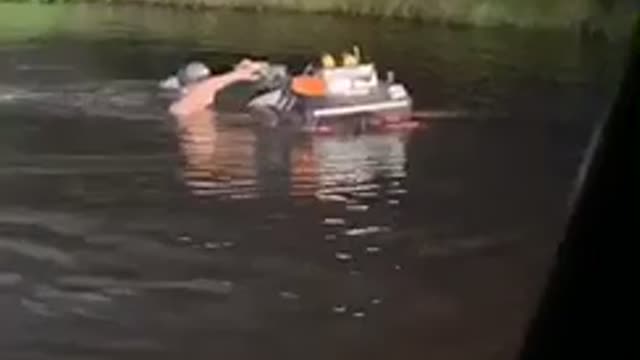 Guy Pushes Four-Wheeler Through the Pond