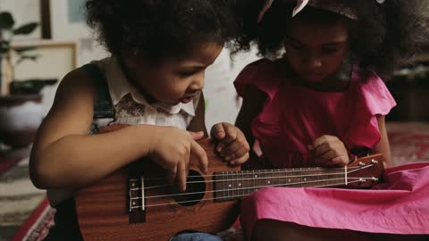 cute kids playing guitar