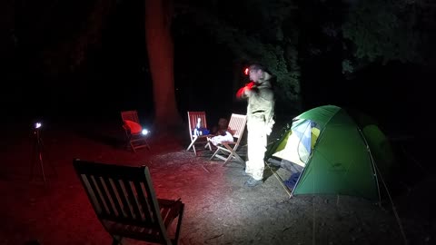 Setting up the filming equipment for a night vlog next to a tent. Nightlapse