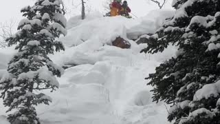 Guy skis down steep mountain and tumbles down, friends laugh