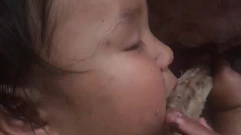 1 year boy eating meat while sleeping