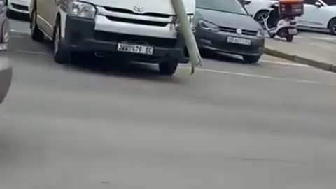 Minibus taxi driving around with road sign stuck on its 'forehead'