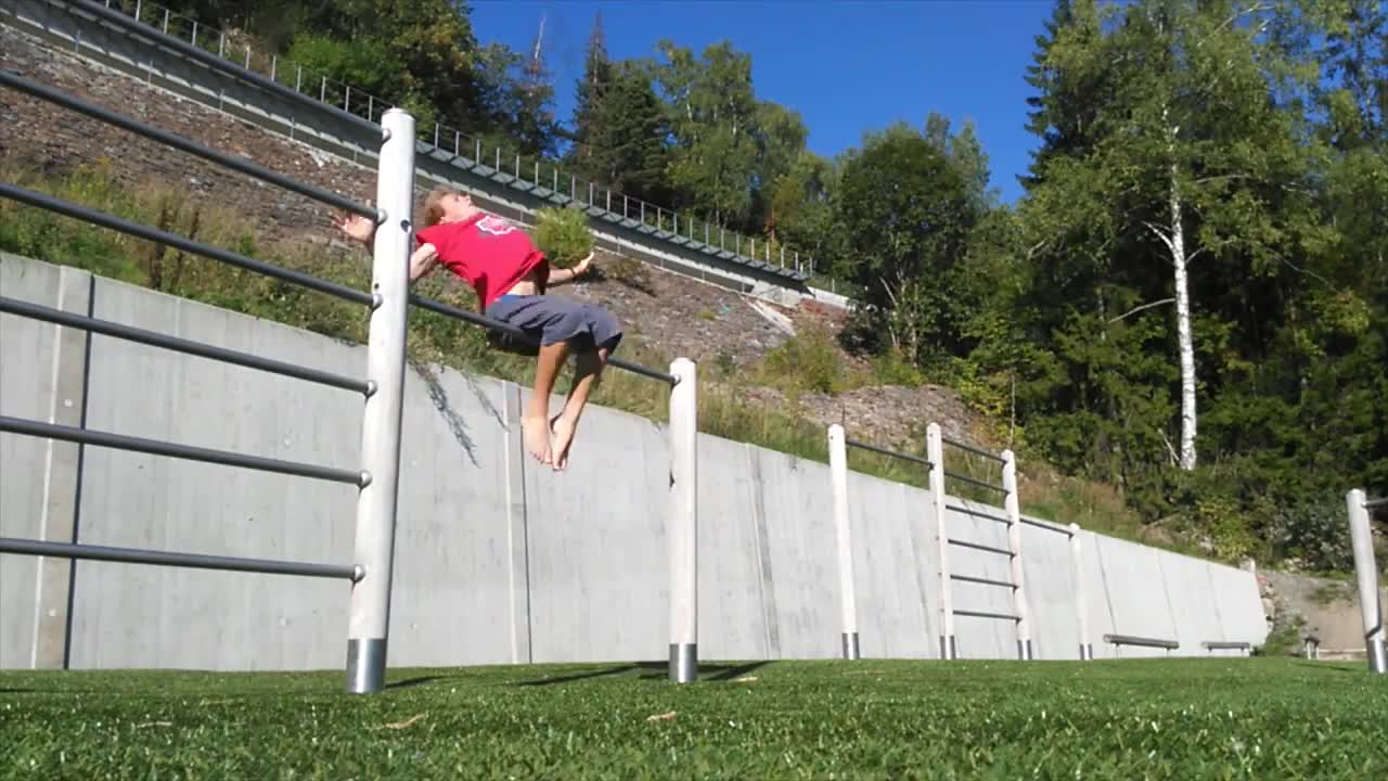 Curly redhead guy flipping on metal pole lands on head