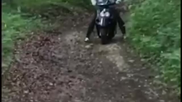 Guy on moped with helmet runs into wood falls off