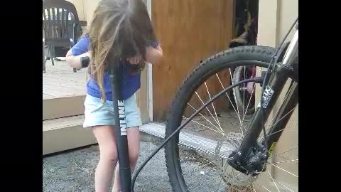 4year old fills up bike tire