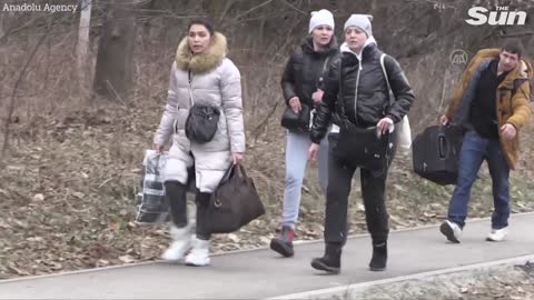 As Russian shelling intensifies in the Ukrainian city of Irpin, residents evacuate.