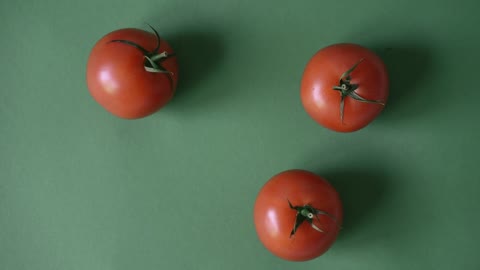 Three Tomatoes on a Flat Surface